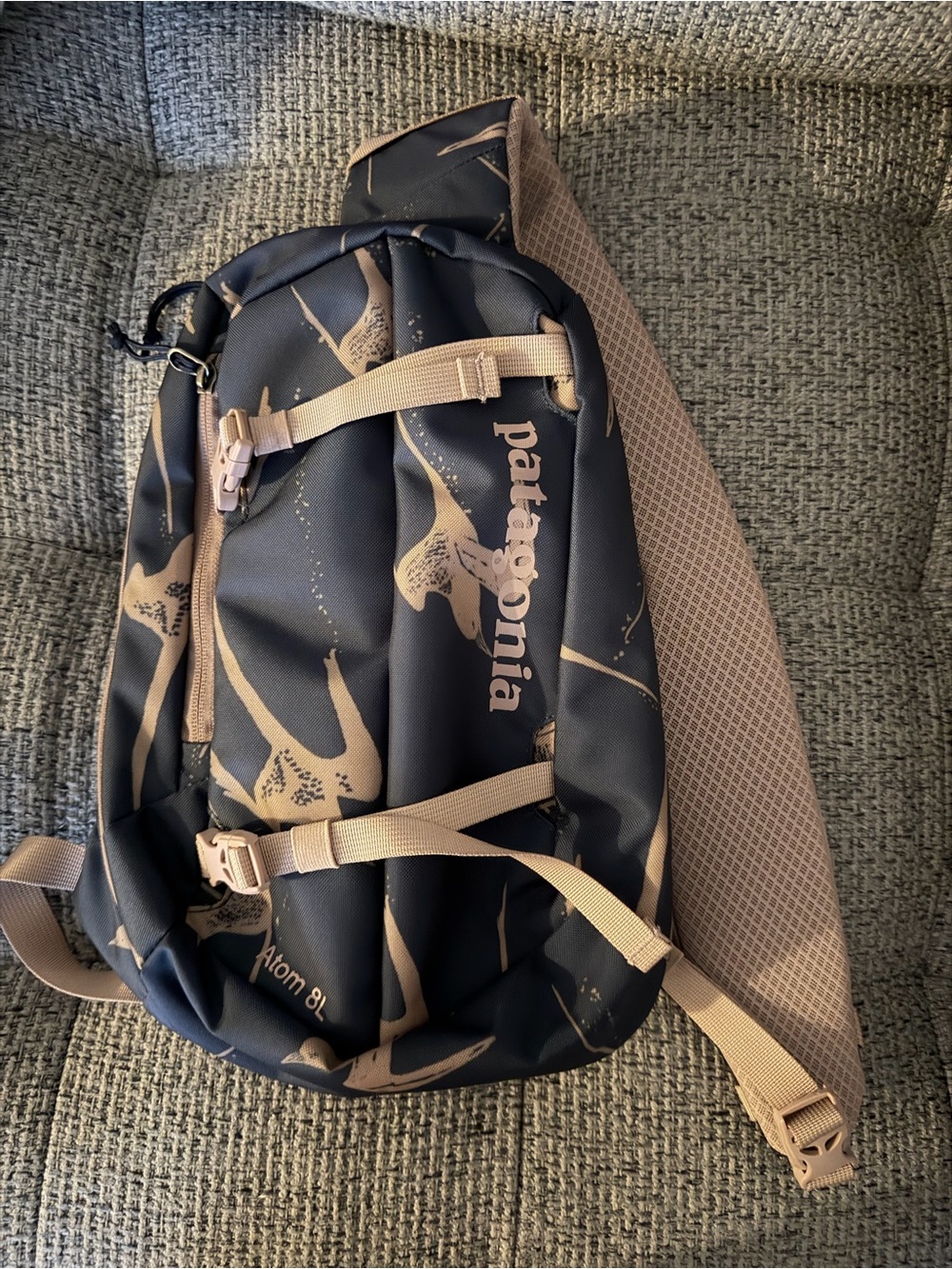 Patagonia sling pack in navy blue with tan accents